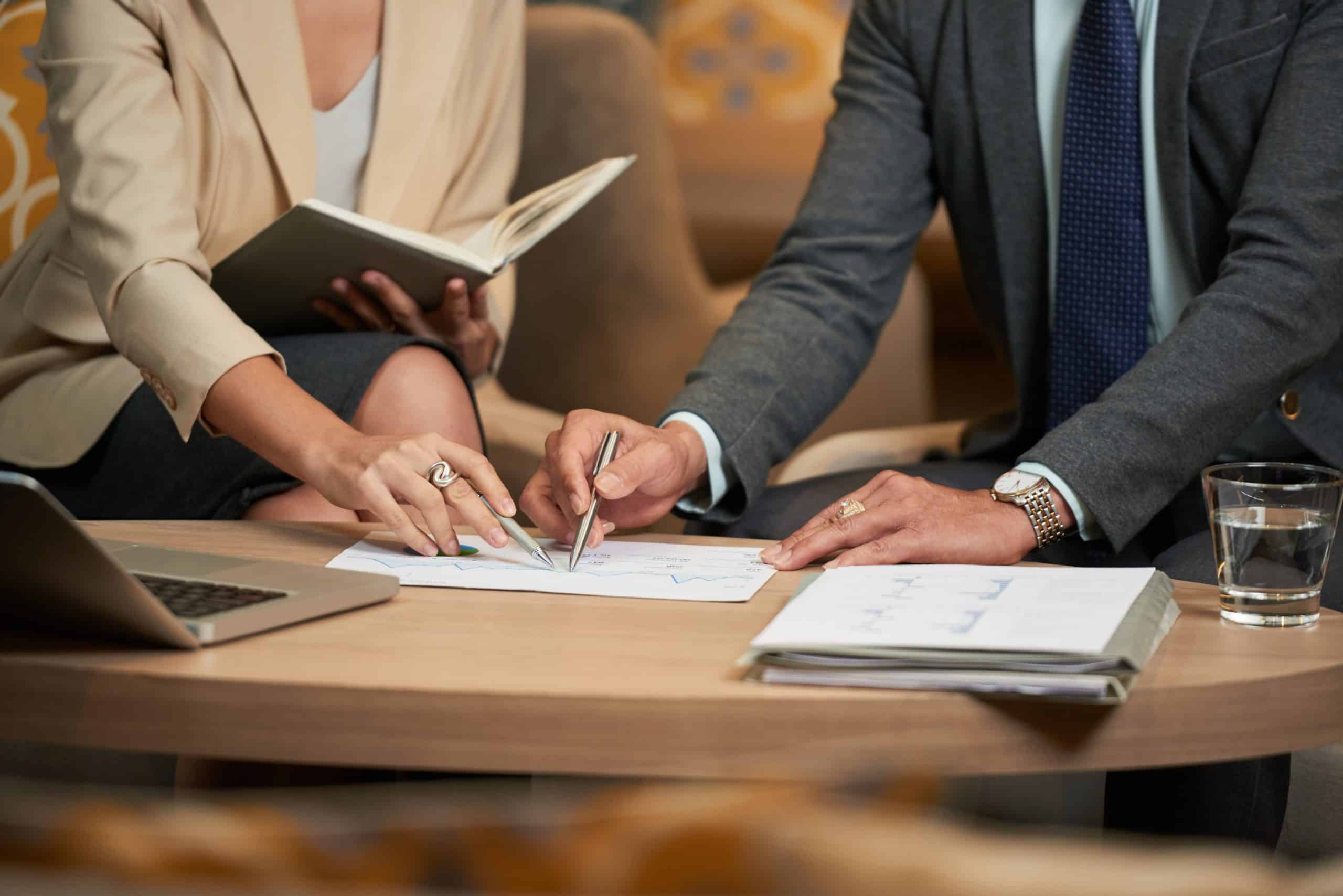 Law Firms 10 Two professionals reviewing documents together at a table, reflecting the peer-level nature of PMRI strategic performance consulting for law firm leadership.